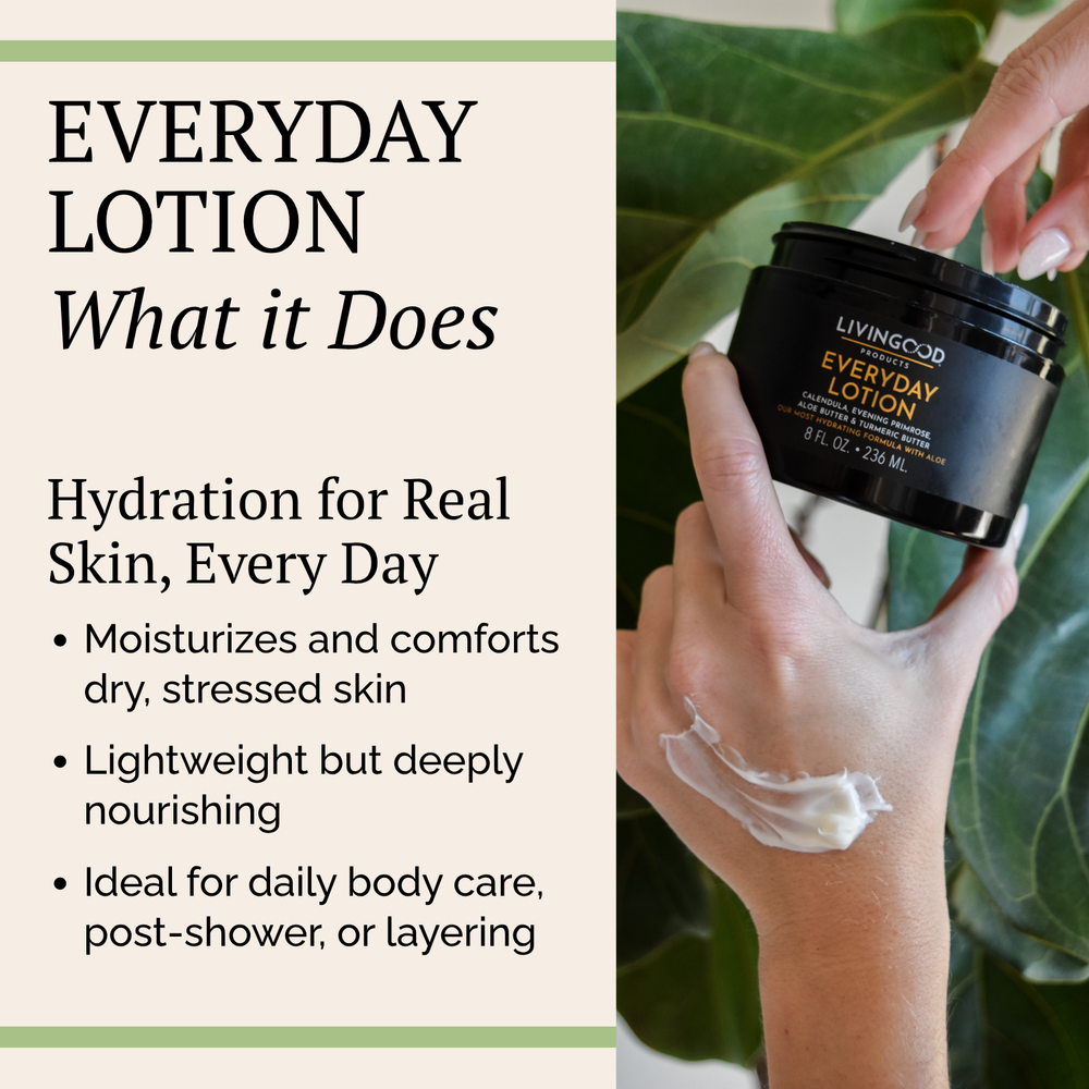 Livingood Skincare Everyday Lotion in an open black jar with its lid leaning against it, showing the white lotion inside, set on a light marble surface.