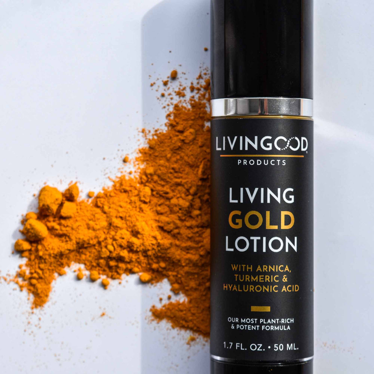 Living Gold Lotion close up with turmeric behind it.
