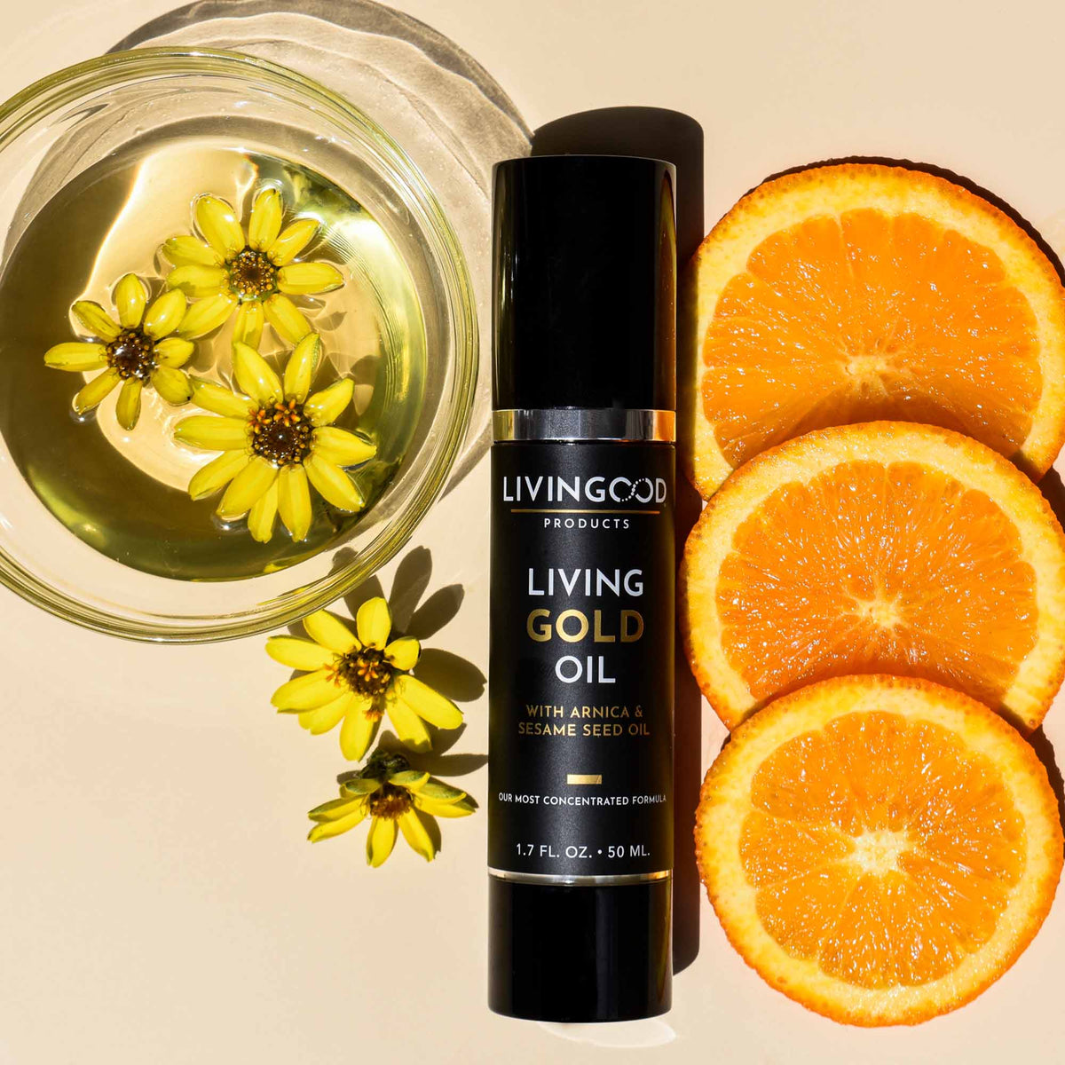 Living Gold Oil on a light orange background with orange slices and yellow flowers