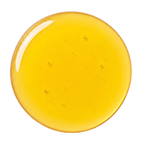 A circular swatch of translucent golden-yellow liquid, resembling honey or oil, isolated on a white background.